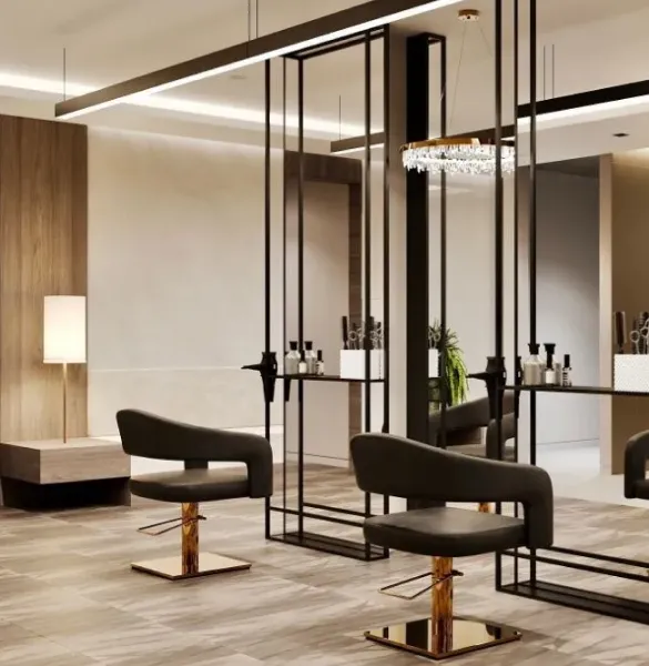 Upscale salon styling area with dark leather chairs, black metal frame mirrors, and crystal chandelier.