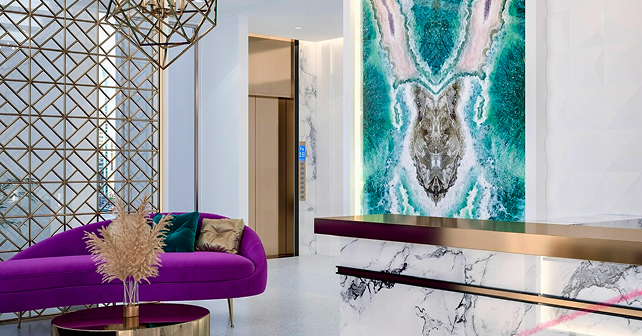 Modern Houston reception area with marble desk and back-lit art wall