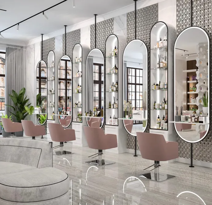 Modern salon with tall lighted mirrors and pink chairs.