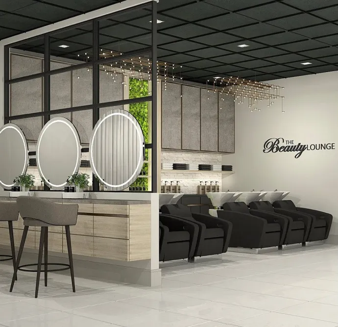 Beauty lounge featuring round lighted mirrors and hair wash stations.