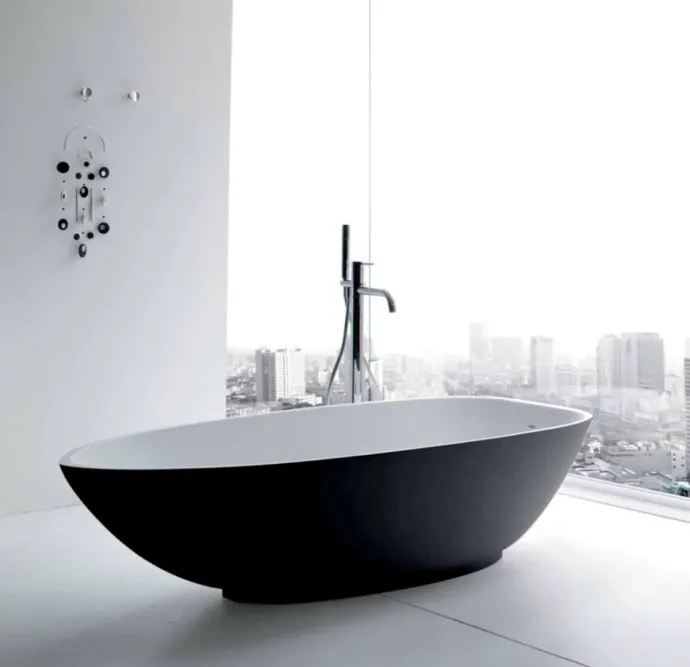 Elegant black and white soaking tub with city views.