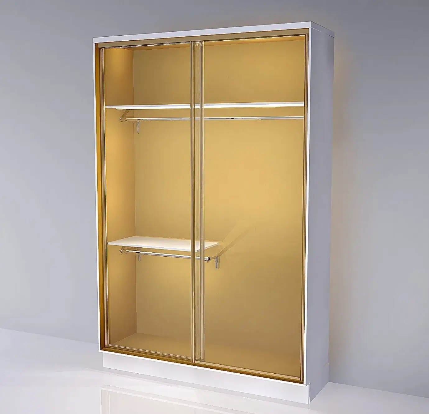 Open wardrobe cabinet with gold/amber mirrored sliding doors, white exterior frame, two chrome hanging rails, two white shelves, and warm interior lighting