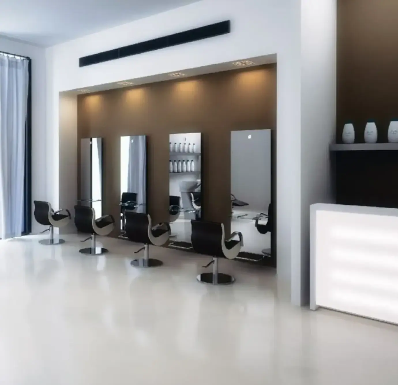 Contemporary hair salon with four black styling chairs lined up against a warm brown accent wall with recessed spotlights, white reception desk, and glossy white floors