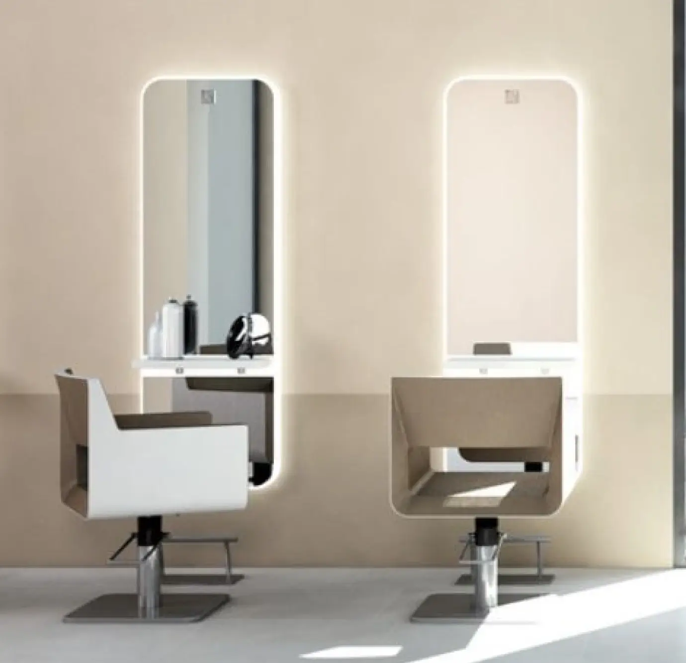 Pair of modern salon styling stations with backlit rounded-rectangle mirrors, angular geometric chairs in white and tan, and a warm beige two-tone wall